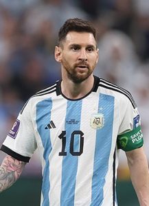 Lionel Messi wearing the Argentina number 10 home jersey and captain's armband during the FIFA World Cup 2022 match against Mexico.