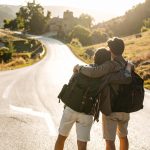 landscape photograph taken from behind walking to a welcome sign