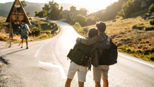 landscape photograph taken from behind walking to a welcome sign