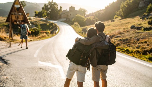 landscape photograph taken from behind walking to a welcome sign