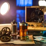 A visual evolution of the first computers in history, showing ancient bronze gears transitioning into glowing 1940s vacuum tubes and modern fiber optics.