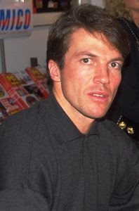 Close-up portrait of Lothar Matthäus from 1995, one of football's legendary captains, wearing a dark collared shirt and looking slightly off-camera.